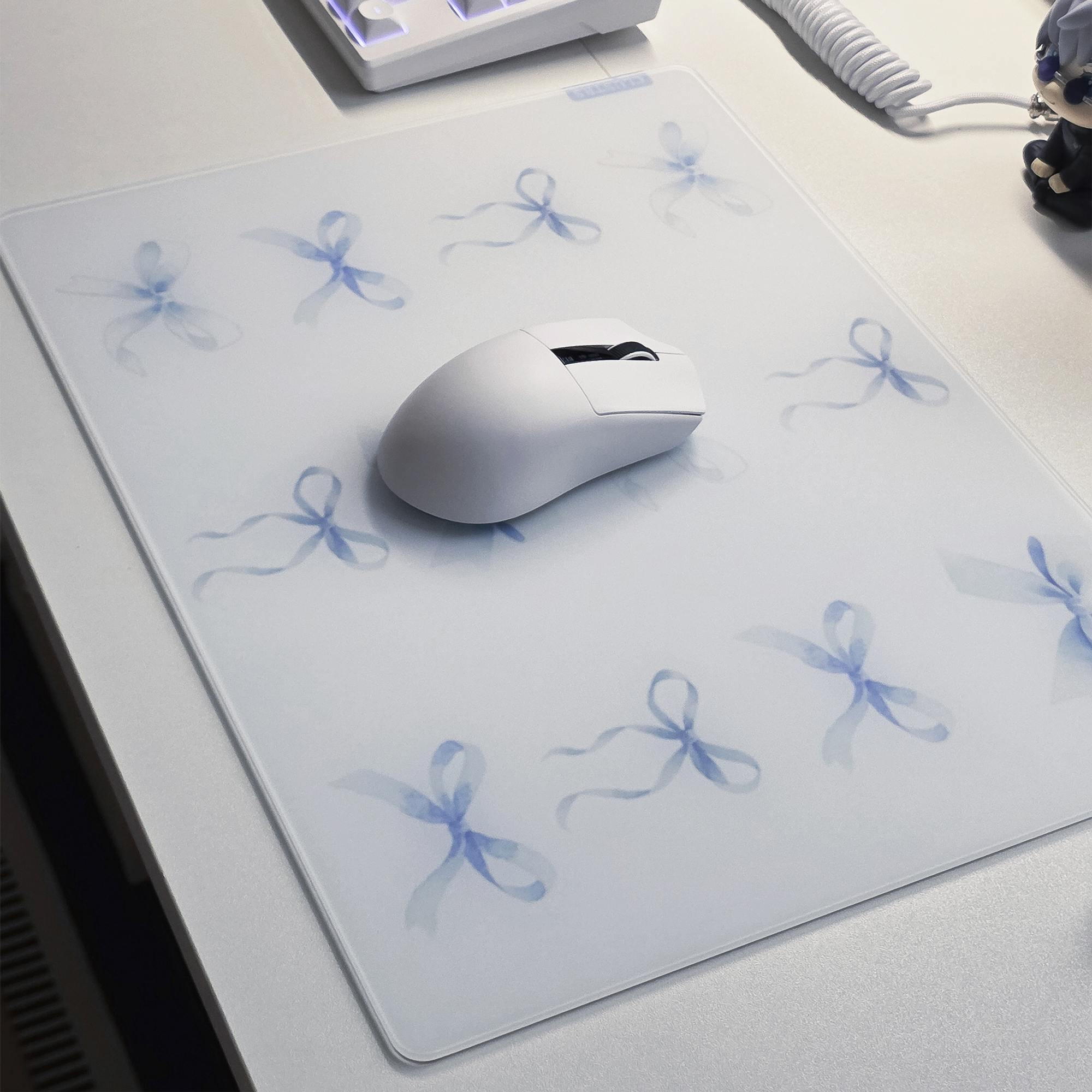 Blue Whisper glass mousepad with a white gaming mouse and keyboard in a clean white desk setup.