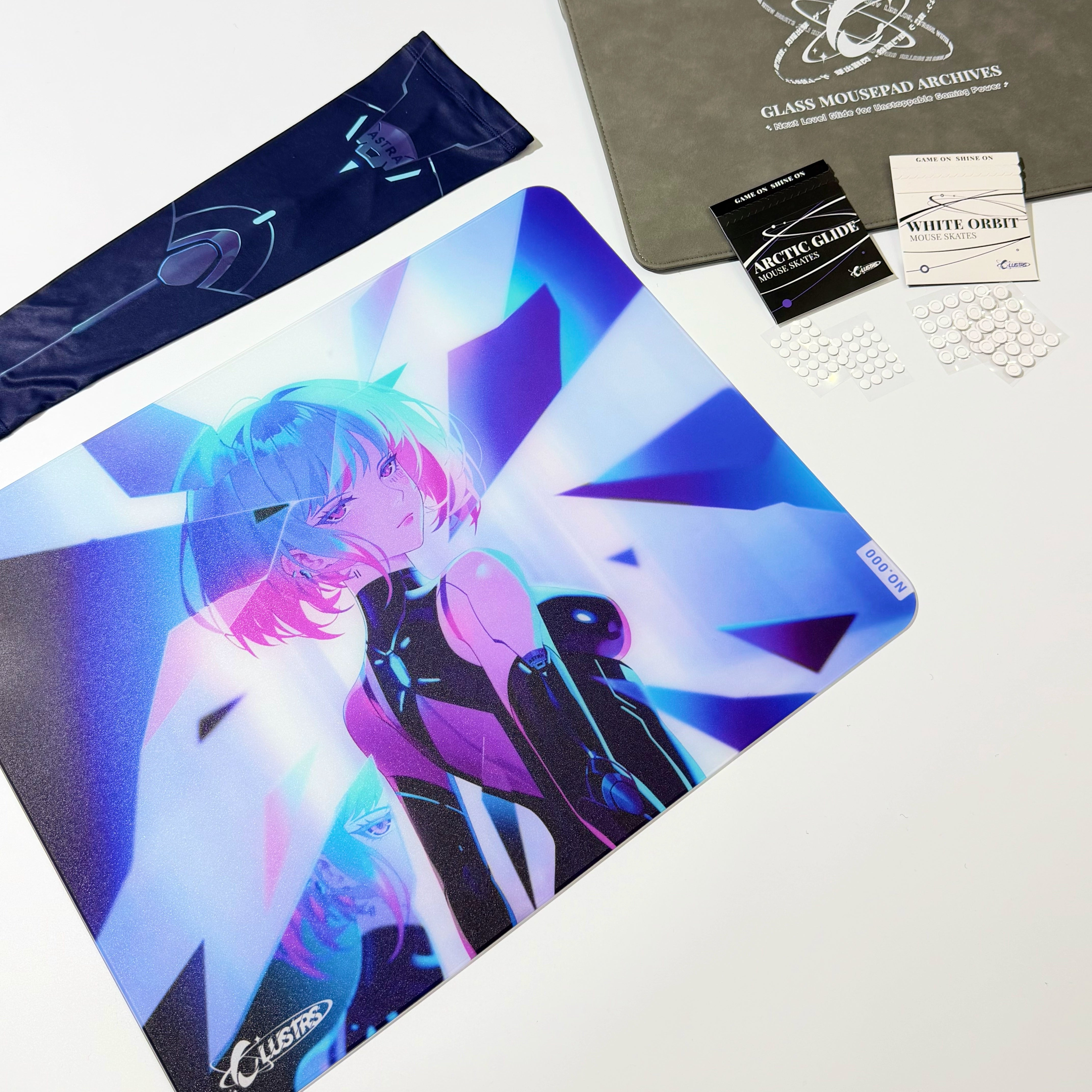 Complete Astra bundle display featuring the Clustrs Astra Glass Mouse Pad with neon anime artwork, matching sleeve, Arctic Glide and White Orbit mouse skates, and protective storage case.