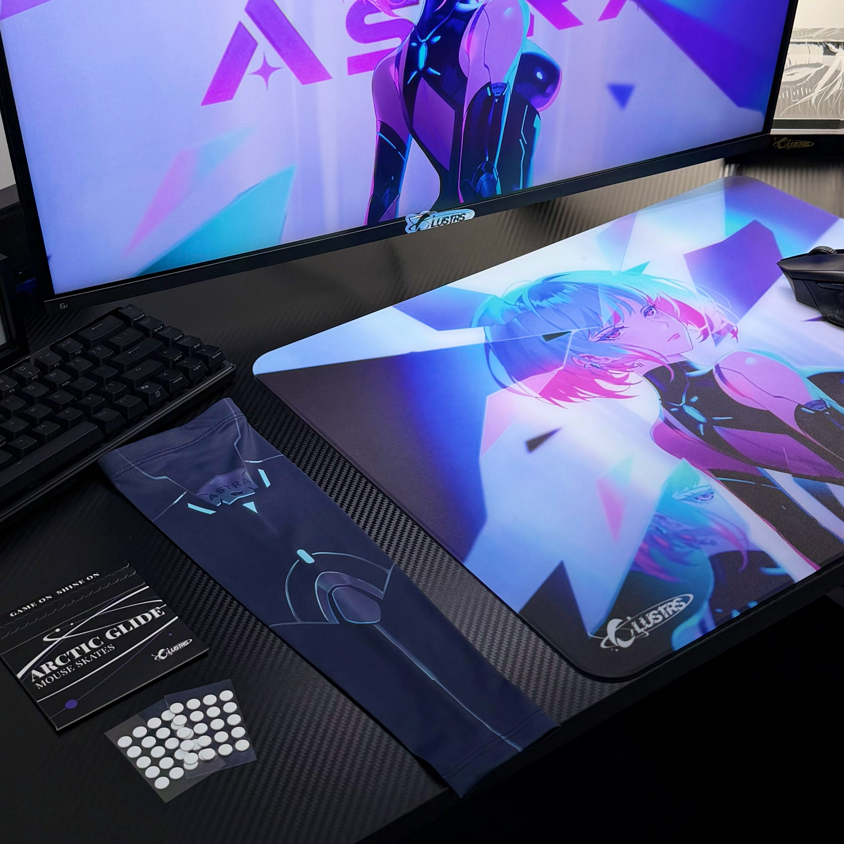 Clustrs Astra Glass Mouse Pad on a carbon-fiber gaming desk, featuring vibrant neon anime artwork, paired with the Astra sleeve and Arctic Glide mouse skates.
