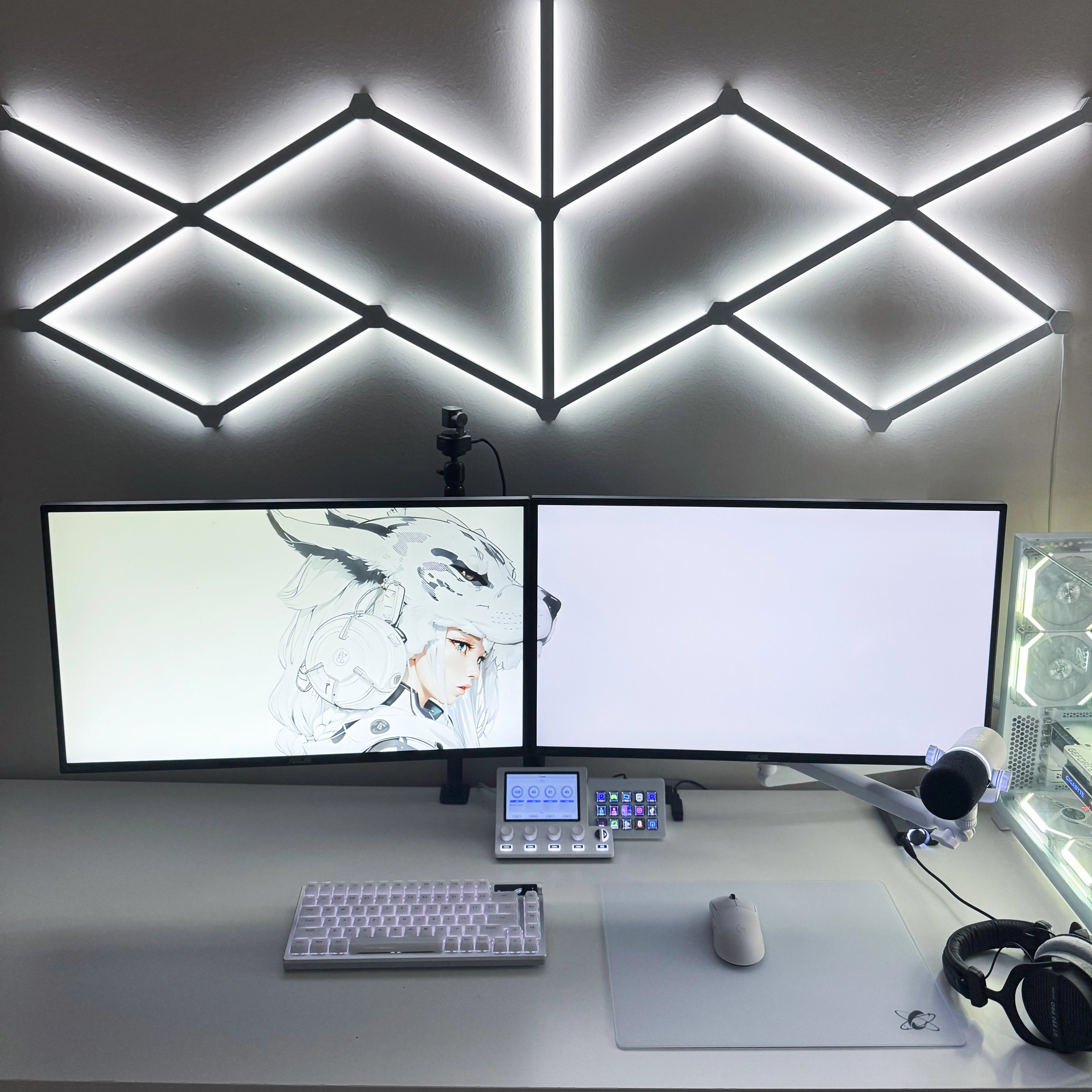 All-white dual monitor desk setup featuring the Clustrs Atom White Glass Pad Pro with a white wireless mouse, compact mechanical keyboard, and LED wall lighting.