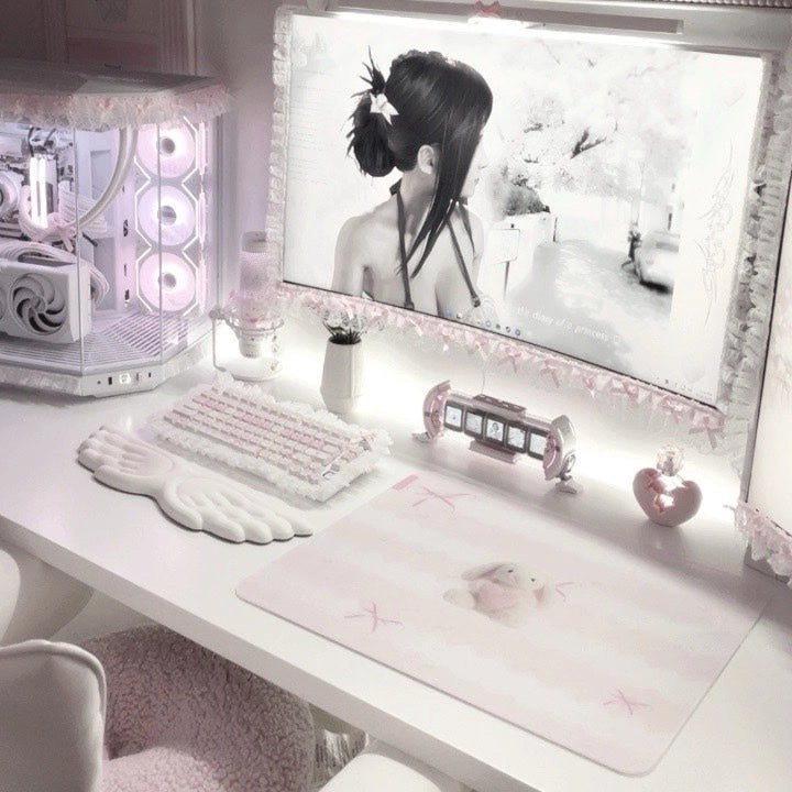 Clustrs Pearl Bunny glass mousepad on a pastel pink kawaii desk setup with white keyboard, wing wrist rest, and pink gaming accessories.