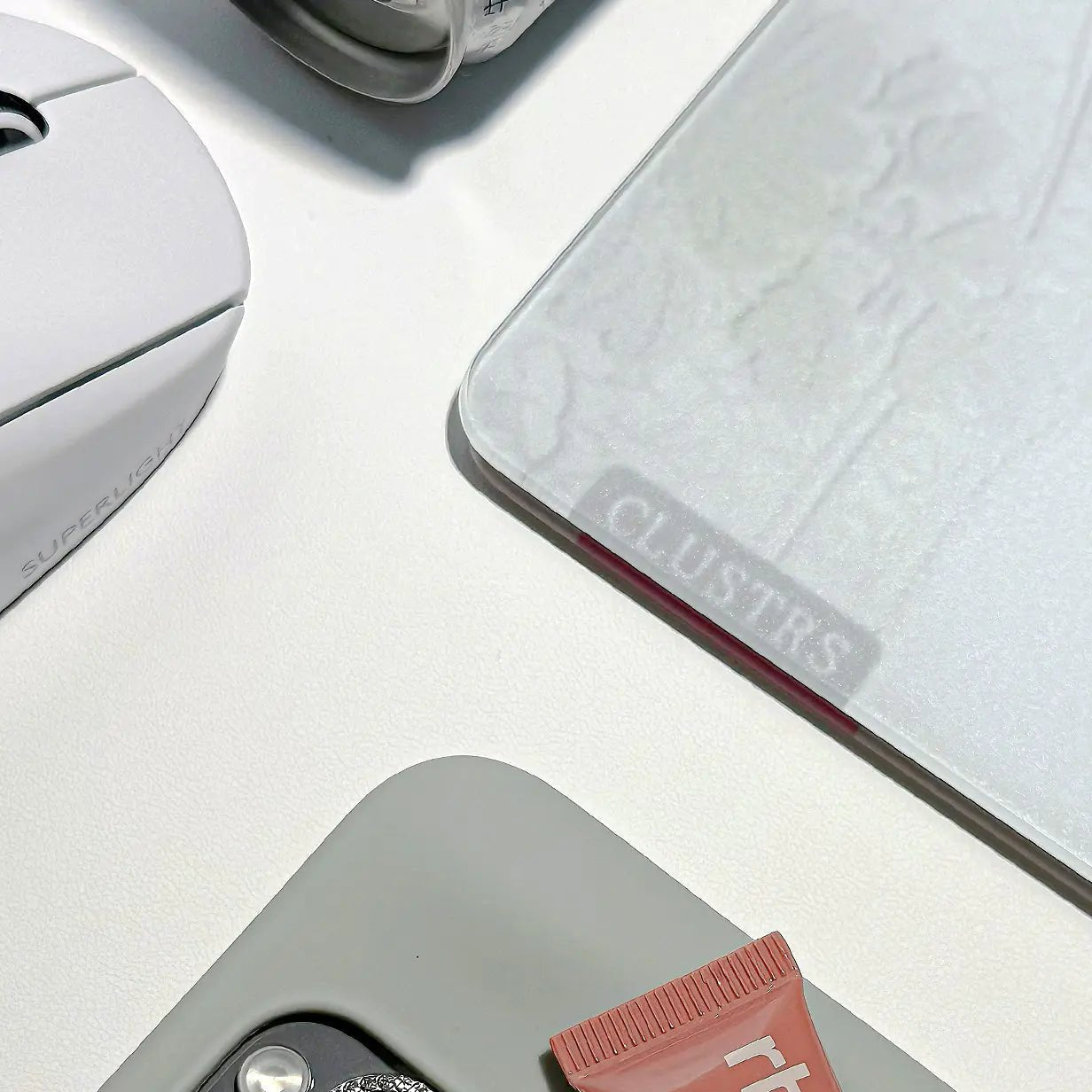 Clustrs White Lacey glass mousepad on a minimalist desk setup