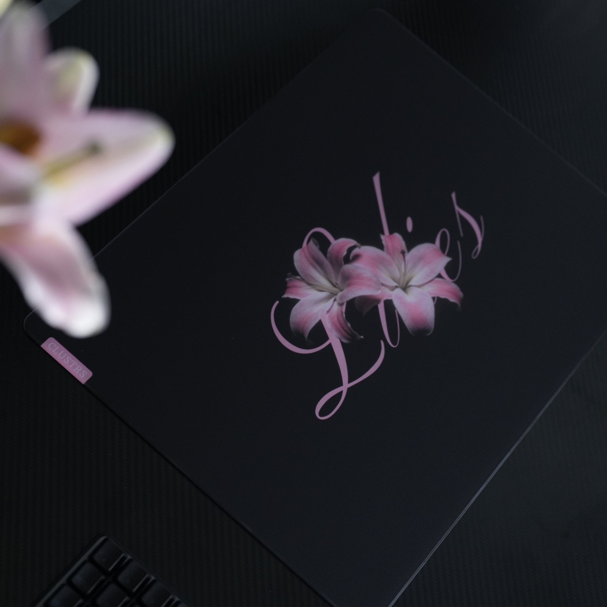 CLUSTRS Lilies glass mousepad with a pink floral design, smooth micro-etched surface, and refined glass finish for gaming, work, and desk setups.