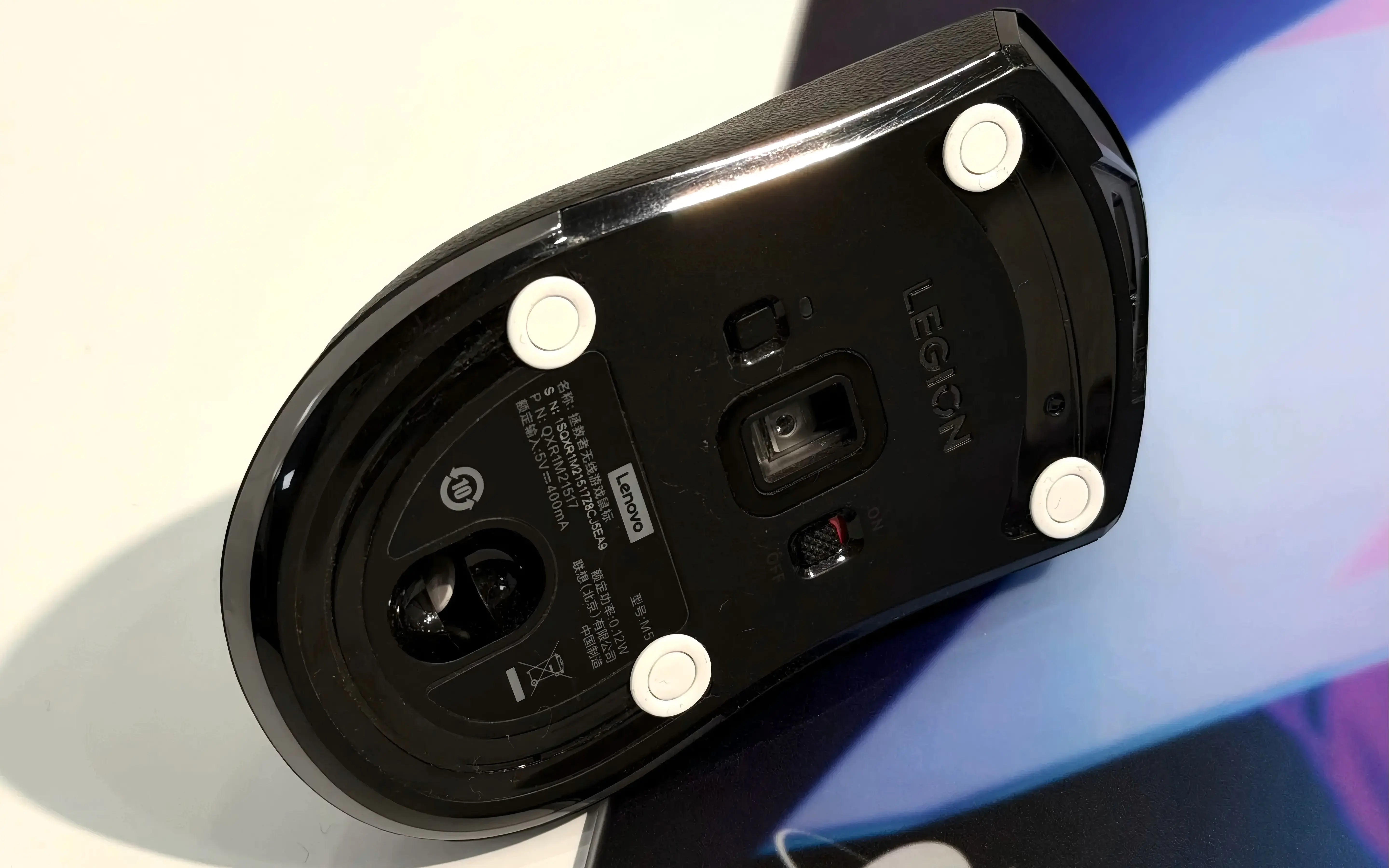 Mouse skates on a gaming mouse used on a glass mouse pad showing when to replace mouse feet for smooth glide