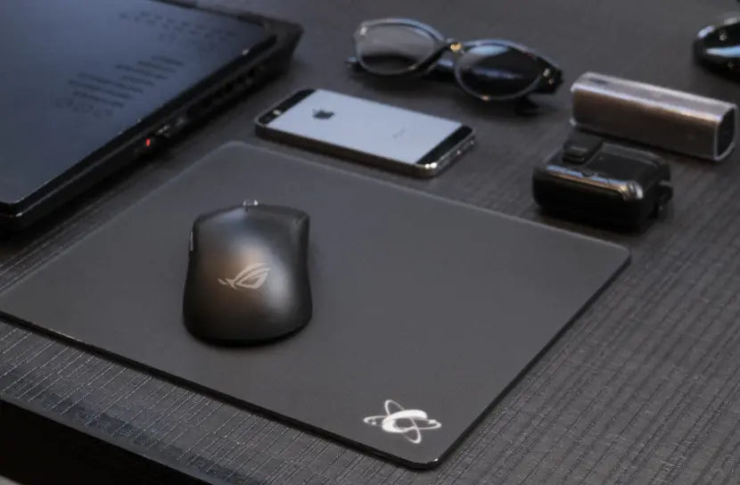 minimalist desk setup with glass mouse pad and laptop