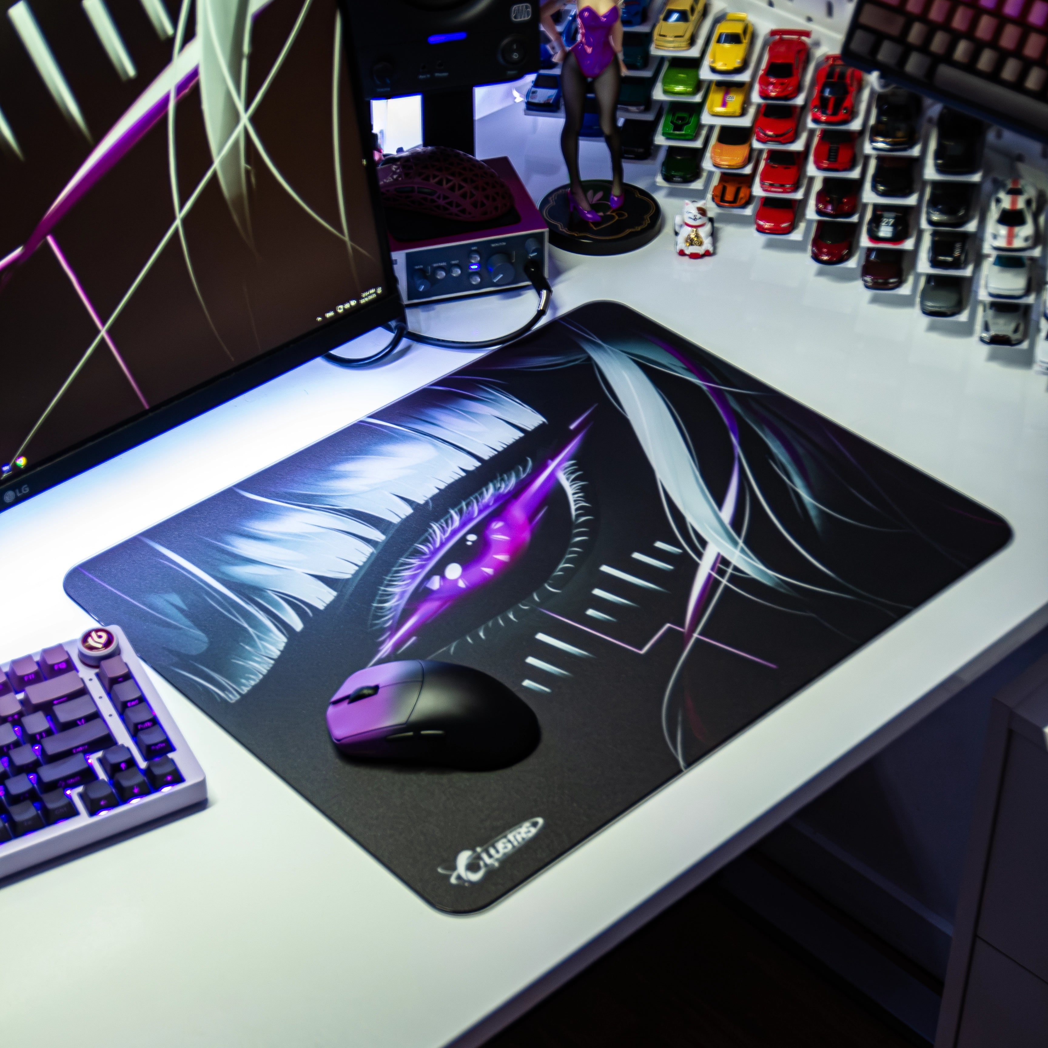 Cyberpunk-themed RGB desk setup featuring the Clustrs Astra’s Gaze Glass Pad Pro with a detailed purple eye design, gaming mouse, and mechanical keyboard.