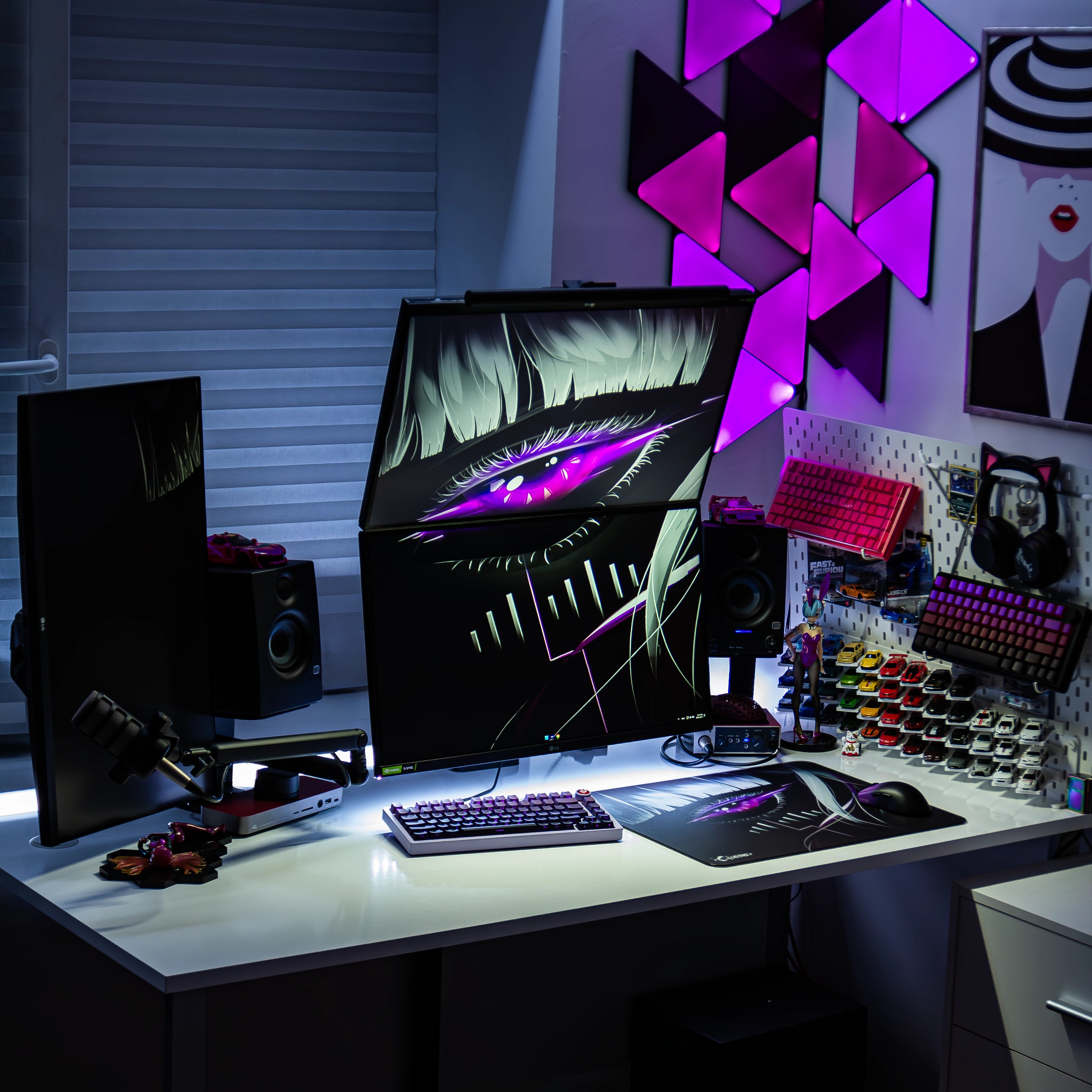 Triple-monitor RGB gaming desk setup featuring the Clustrs Astra’s Gaze Glass Pad Pro with matching purple cyberpunk eye theme, mechanical keyboard, figurines, and wall lighting.