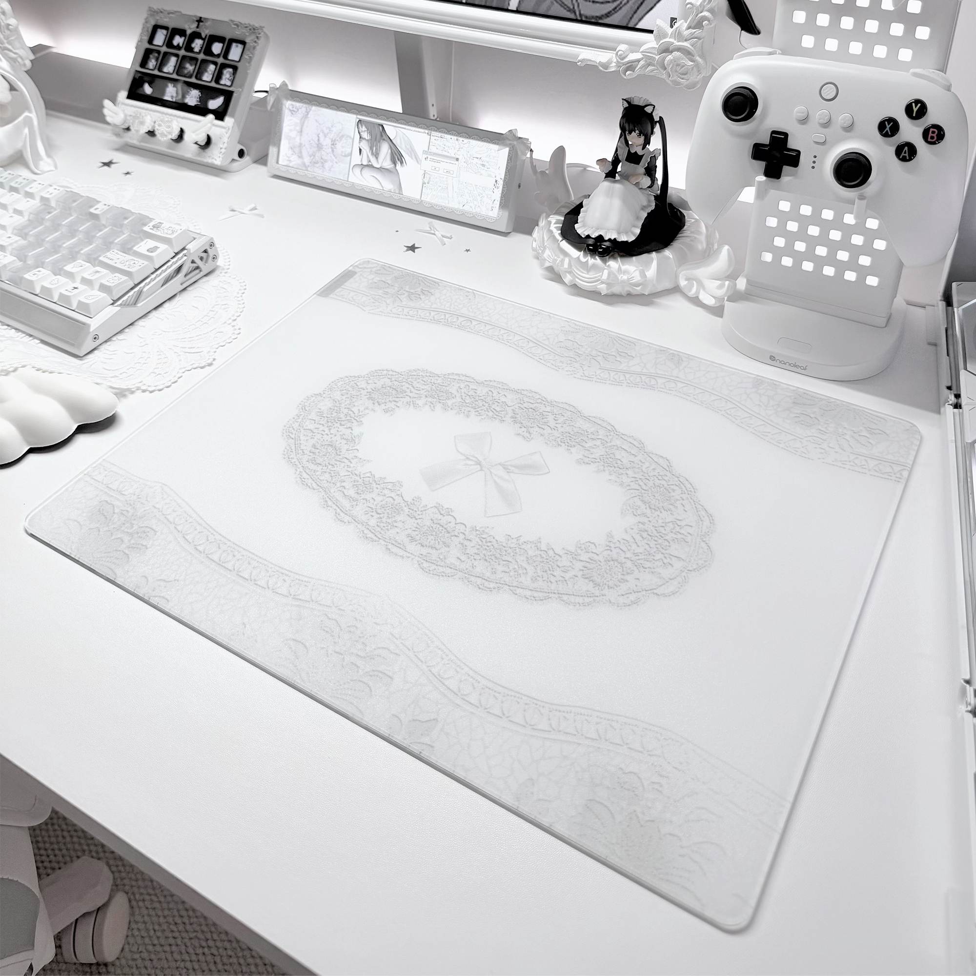 CLUSTRS White Lacey glass mousepad displayed in an all-white desk setup with a keyboard, controller, and anime-inspired accessories.