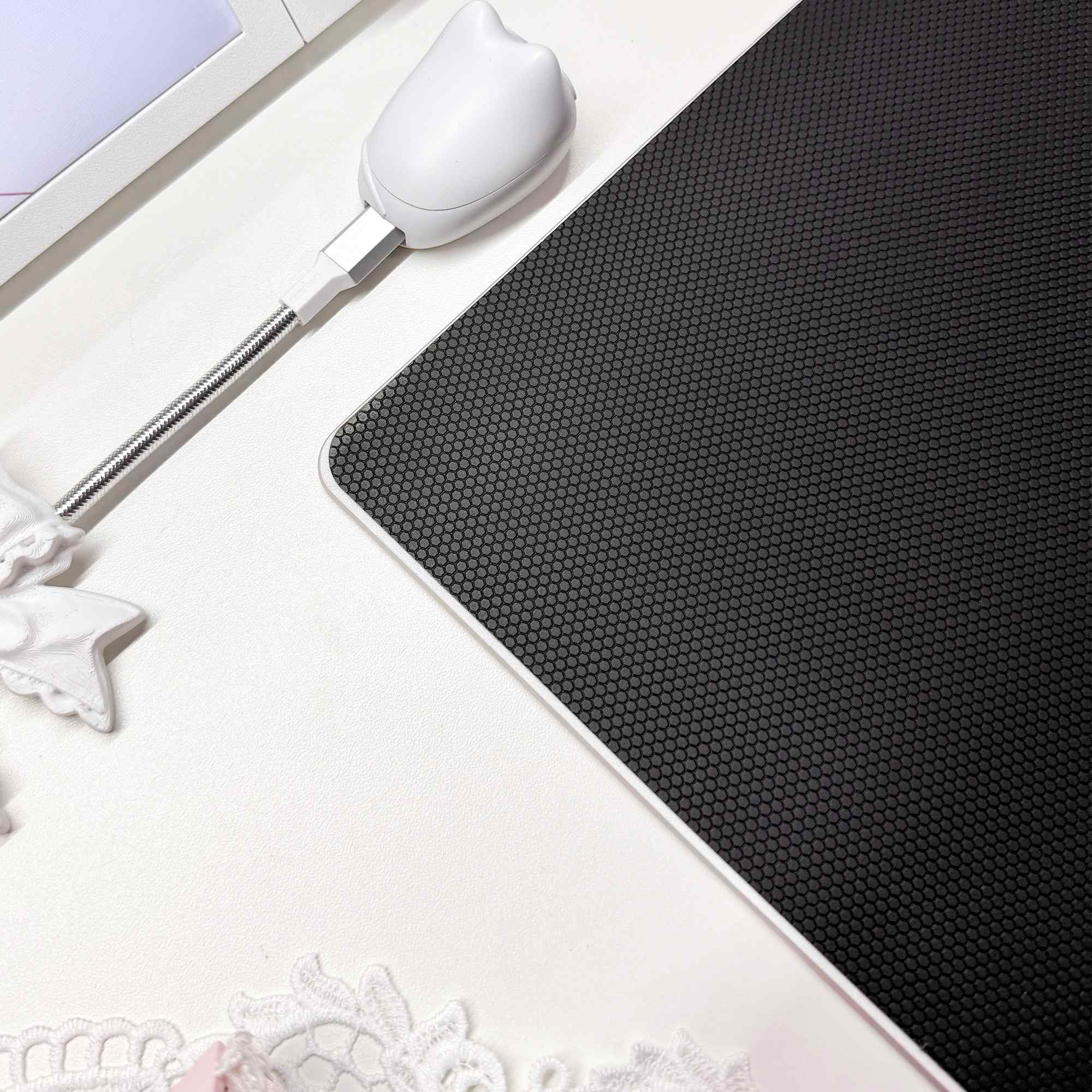 Black honeycomb non-slip base on the underside of the Pearl Bunny glass mousepad.