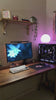 Creator unboxing the CLUSTRS Black Lilies glass mousepad, featuring pink floral artwork and a smooth glass surface for aesthetic gaming setups.